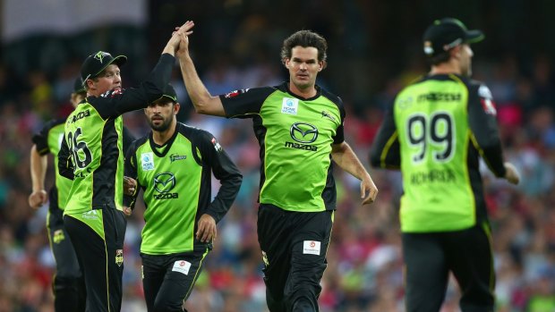 Green machine: Clint McKay and the Thunder celebrate the wicket of Michael Lumb of the Sixers in last weekend's Sydney derby.