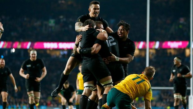 Celebration: Sonny Bill Williams jumps on the huddle after Ma'a Nonu scores New Zealand's second try.