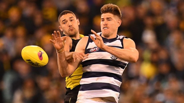 On the prowl: Versatile Tiger Shaun Grigg pressures Geelong's Zac Smith in Friday night's qualifying final.