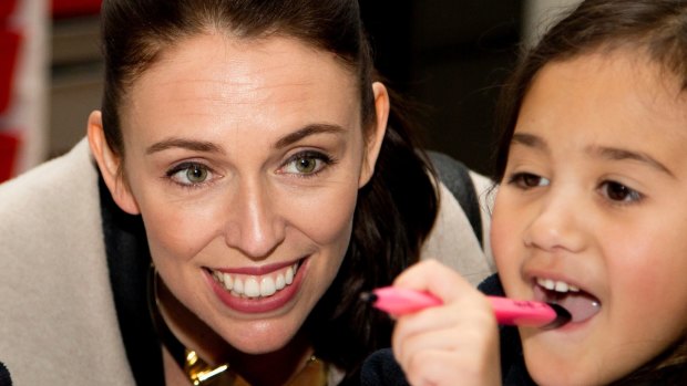 New Zealand Labour Party leader Jacinda Ardern sits with a student in their classroom during a visit to Addington School in Christchurch.
