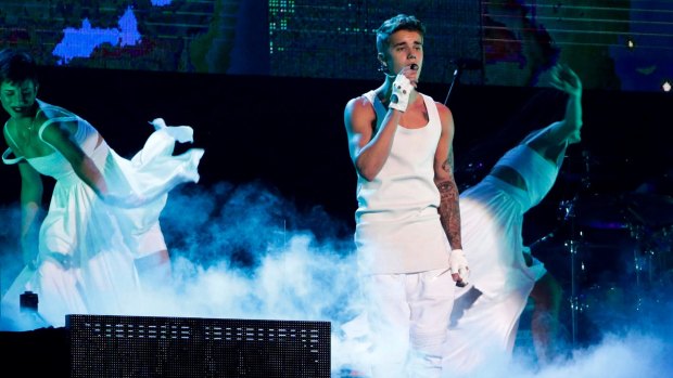 Justin Bieber performing on a stage during his world tour concert in Beijing in 2013.