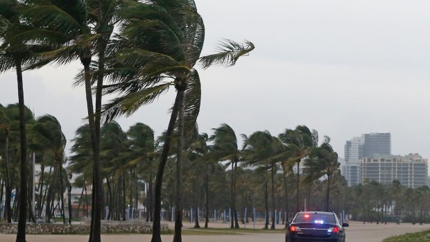 Miami Beach Police patrol Miami Beach as storm closes in.