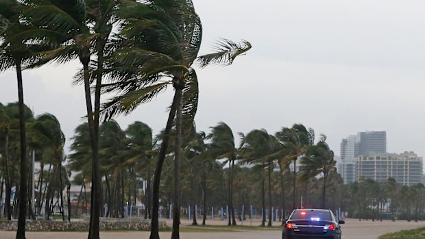 Miami Beach Police patrol Miami Beach as storm closes in.