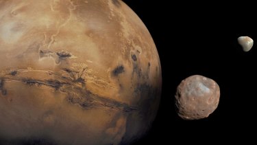 A representation of Mars with its small moons, Deimos and Phobos.