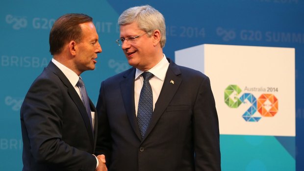 Allies: Australian Prime Minister Tony Abbott, left, and Canadian Prime Minister Stephen Harper shake hands. At the G20 summit, the Canadian leader bluntly told Russian President Vladimir  Putin to "get out of Ukraine". 