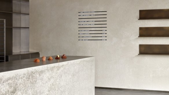 The store features many of Lune's design signatures, such as a minimalist aesthetic and poured concrete surfaces.