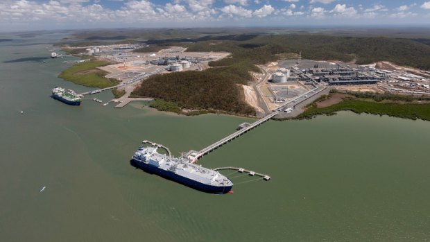 An aerial view of the three LNG projects on Curtis Island all with ships at their jetties. 