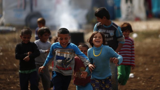 Kids play at a refugee camp in the town of Hosh Hareem in Lebanon. The United Nations says the war in Syria has left 13.5 million people in need of aid and protection, including more than six million children.