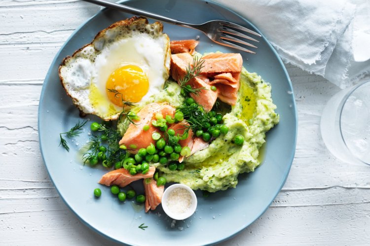 Ocean trout with green mash, peas and a fried egg.