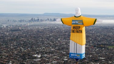 Hot air: the balloon in shape of Rio's Christ the Redeemer statue floats over Melbourne.
