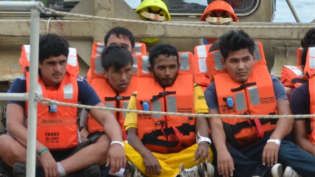 A boat load of asylum seekers arrive on Christmas Island.