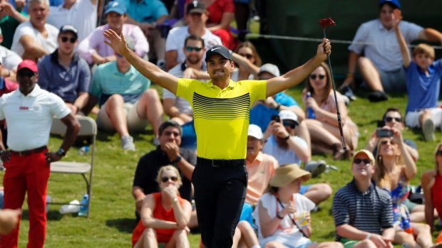Good drop: Jason Day celebrates after sinking a 60-foot putt on his way to a seven-under round of 63.