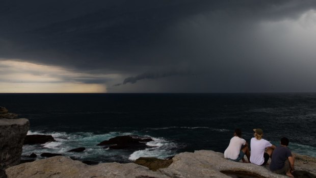 People watch the storm clouds at North Bondi on Friday.