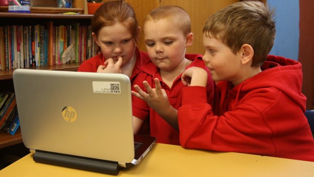 Maddie, year 4, Ben, year 1 and Lewis, year 4, from Darlington Public School beta testing the computer maths games the year 4 students had developed to teach younger children.
