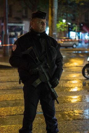 A riot police officer stands guard near the Bataclan concert hall.