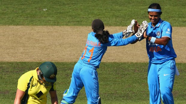 Long walk: Australia's Grace Harris trudges off after being dismissed by India's Shikha Pandey.