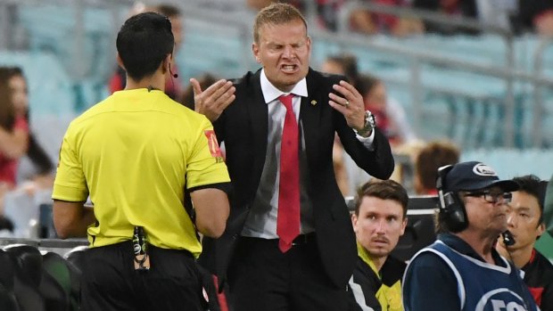 Point of dispute: Wanderers coach Josep Gombau argues with the fourth official.