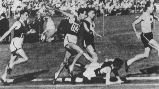 The moment in 1956: John Landy jumps over a fallen Ron Clarke at Olympic Park. He stopped to check that Clarke was OK.