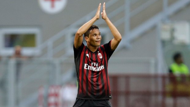 AC Milan's Carlos Bacca applauds fans as he walks off the pitch.