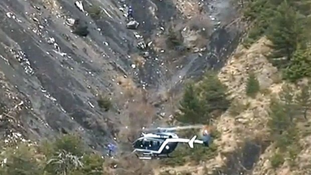 Reassurance sought: A rescue helicopter from the French Gendarmerie hovers in front of the crash site of an Airbus A320, near Seyne-les-Alpes. All 150 people on board died.