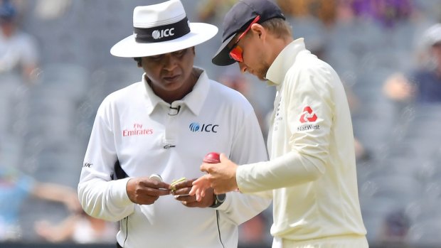 England skipper Joe Root and umpire Sundaram Ravi have a discussion about the state of the the ball.