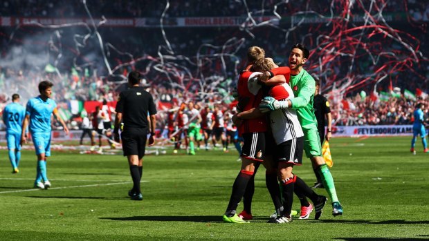 Jones (in green) celebrates Feyenoord's win in the Dutch Eredivisie.