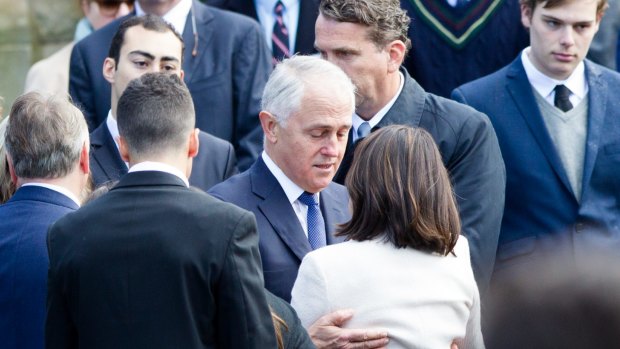 Prime Minister Malcolm Turnbull hugs Kathy Kelly at her son Stuart Kelly's funeral.