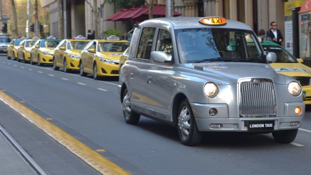 The grey cab seats six people and has a wall to separate the driver from four passengers in the back seat.