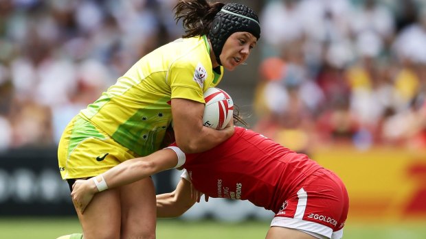 Adversity: Sharni Williams is tackled during the semi-final match between Australia and Canada.