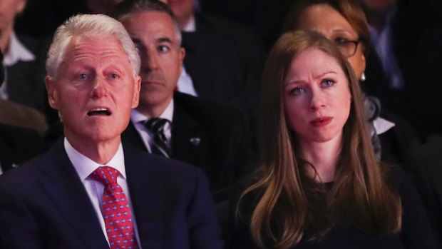 Former president Bill Clinton and daughter Chelsea listen during the presidential debate.