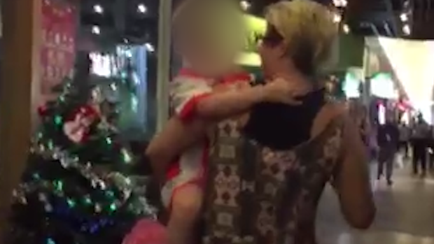 Eliza Szonert holds her son after taking him from a Kuala Lumpur restaurant.