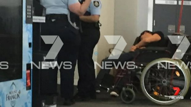 This image, sent to Seven News, purports to show Grant Hackett slumped over next to police at Melbourne Airport.