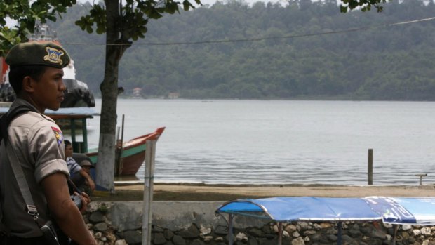 A policeman guards a harbour in Cilacap in Central Java near Nusakambangan prison island in 2008. 