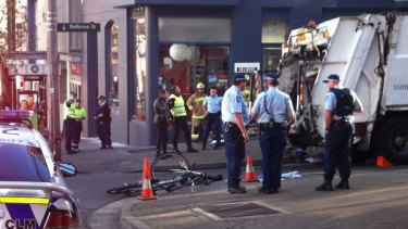 Cyclist trapped under a garbage truck in Surry Hills.