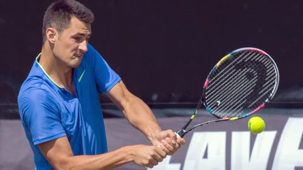 Bernard Tomic's preparation for Wimbledon was dealt a blow, as he was knocked out of the Halle grasscourt event in Germany.