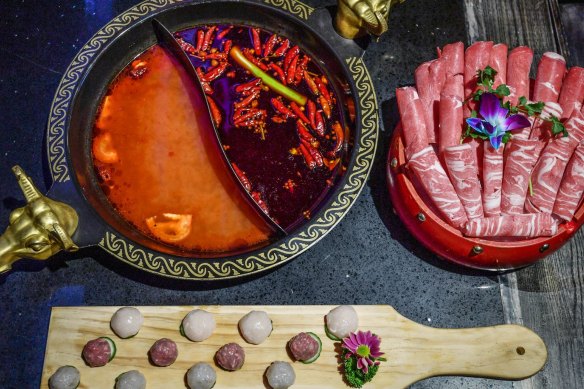 Oxtail hotpot divided into spicy and not spicy,  pictured with a combination beef and lamb platter and fish and meat balls.