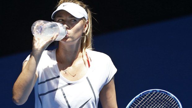 Thirsty work: Russia's Maria Sharapova tops up at Sunday's practice session.