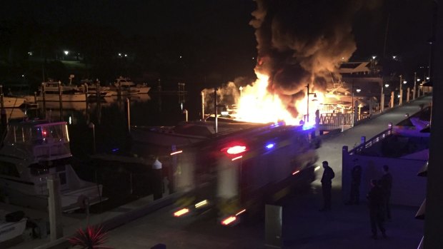 Firefighters at Finger Wharf in Woolloomooloo  as flames engulf two vessels.