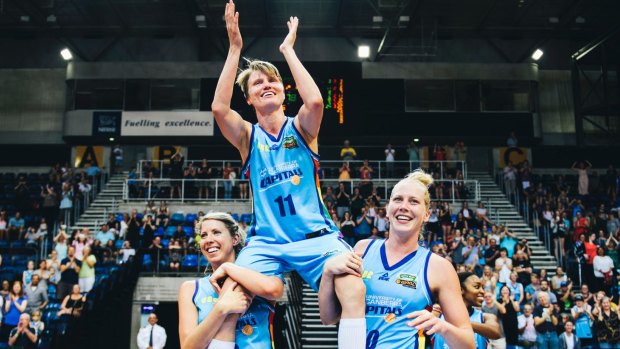 On a high: Jess Bibby is chaired off after her last WNBL game but now has her sights on Australian football.