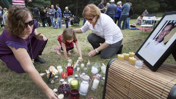 Sarah Canham, left, and daughter Ada, 4,   with Zee Meyer at a vigil for missing man and Meyer’s husband, Warren.