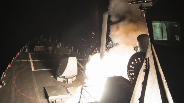 In this image provided by the US Navy, the USS Ross (DDG 71) fires a tomahawk land attack missile on Friday, April 7, from the Mediterranean Sea. .