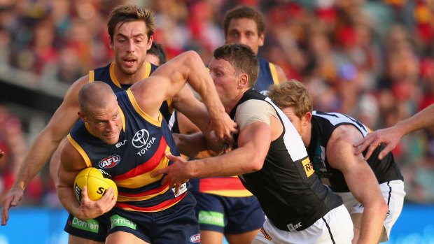 Caught Crow: Scott Thompson tries to break free against Port Adelaide. 