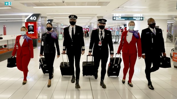 The Virgin Australia pilots and crew model the long johns before the flight.