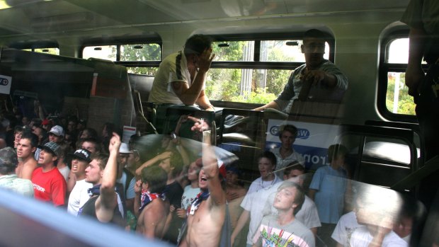 Two youths sit in the train after Sergeant Craig Campbell forced a mob of men back to the station.