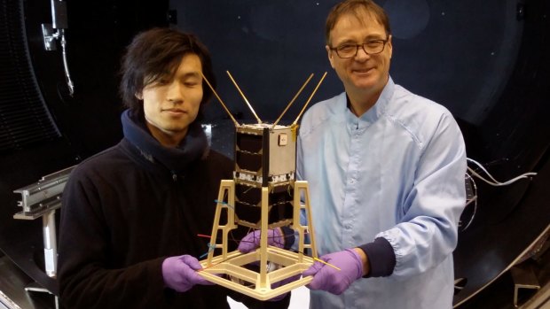 Professor Iver Cairns (right) and PhD student Jiro Funamoto with the CubeSats to be launched from the International Space Station early next year.