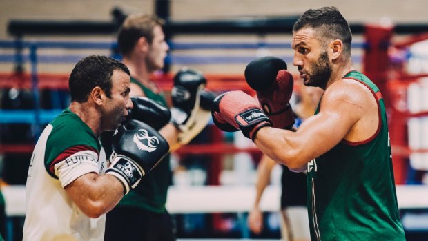 Boxer Dave Toussaint takes Robbie Farah through a session at the AIS in January.