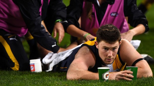 Jeremy McGovern of the West Coast Eagles is worked on by the physics at three quarter time during the 2015 AFL round 19 match between the West Coast Eagles and the Hawthorn Hawks at Domain Stadium.