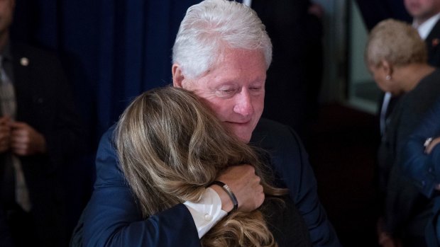 Former President Bill Clinton hugs a woman after his wife, Democratic presidential candidate Hillary Clinton spoke in New York on Wednesday.