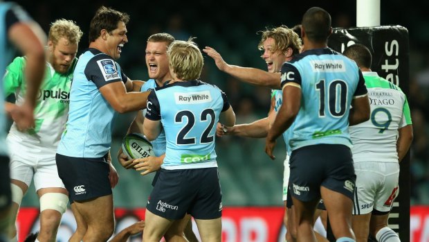 Back in it: The Waratahs celebrate Tom Robertson's try against the Highlanders.