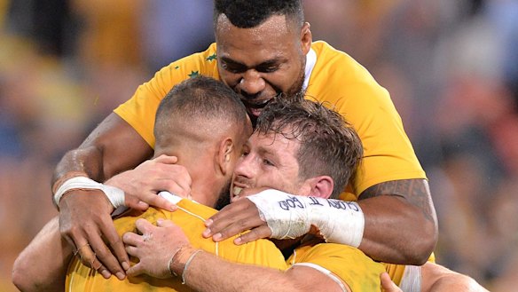 Morale-booster: Bernard Foley is mobbed after scoring a crucial five-pointer.